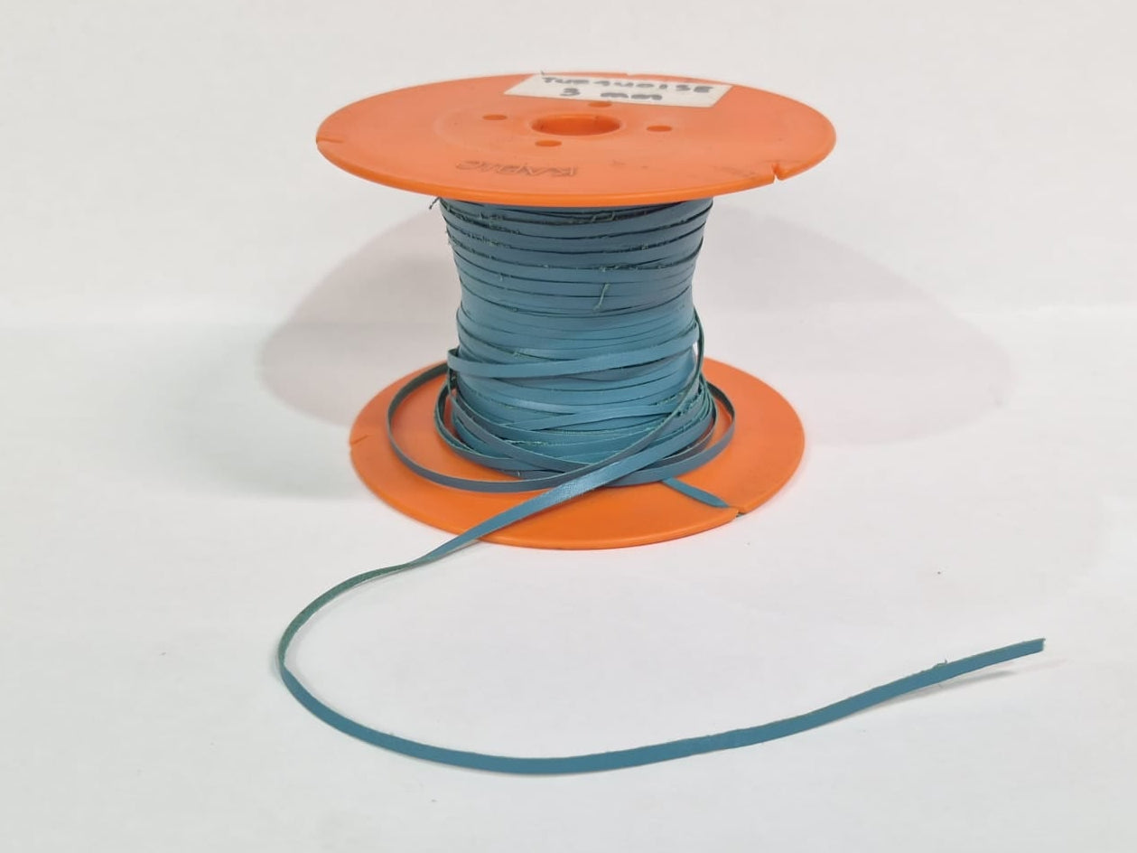 A spool of light blue leather lace wound on an orange plastic core, with a short length of the blue material draped in front, set against a plain white background.